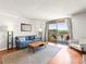 Inviting living room with balcony offering city views and comfortable modern furnishings at 1301 Speer Blvd # 702, Denver, CO 80204