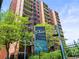Condominium community signage and surrounding greenery at The Denver Tower at 1301 Speer Blvd # 702, Denver, CO 80204