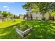 Expansive backyard with lush green grass, mature trees, and raised garden beds for planting at 11199 Dahlia Pl, Thornton, CO 80233