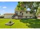 Well-maintained backyard with lush green grass, a mature tree, and a deck attached to the house at 11199 Dahlia Pl, Thornton, CO 80233