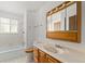 Bright bathroom with a single sink vanity, medicine cabinet, and shower-tub combination at 11199 Dahlia Pl, Thornton, CO 80233