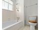 Clean bathroom with a standard bathtub-shower combination and a toilet with a wood seat at 11199 Dahlia Pl, Thornton, CO 80233