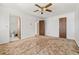 Bedroom featuring a ceiling fan, neutral carpet, en-suite bathroom and an additional closet at 11199 Dahlia Pl, Thornton, CO 80233
