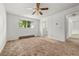 Large bedroom with white walls, fan and a view to the en-suite bathroom at 11199 Dahlia Pl, Thornton, CO 80233