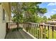 View of wooden deck with railing overlooking a fenced yard and mature trees providing shade at 11199 Dahlia Pl, Thornton, CO 80233