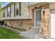 Close-up of the brick and siding facade of a two-story suburban home at the front entry at 11199 Dahlia Pl, Thornton, CO 80233