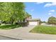Suburban two-story house with white garage door and large lawn in a sunny, residential neighborhood at 11199 Dahlia Pl, Thornton, CO 80233