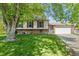 Charming two-story home with a well-manicured lawn and a two-car garage at 11199 Dahlia Pl, Thornton, CO 80233