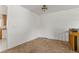 Corner of living room with neutral carpet, leads to kitchen and stairs to basement or other level at 11199 Dahlia Pl, Thornton, CO 80233