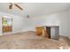 Open living room with carpet flooring and natural light from the kitchen view and stairs to a basement or lower level at 11199 Dahlia Pl, Thornton, CO 80233