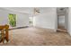 Bright, airy living room featuring neutral walls and large windows, complemented by soft, plush carpeting at 11199 Dahlia Pl, Thornton, CO 80233