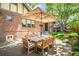 Spacious patio with dining set for outdoor entertaining in a brick-laid backyard at 2604 Elm St, Denver, CO 80207