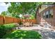 Backyard patio with dining table, chairs, and lush landscaping at 2604 Elm St, Denver, CO 80207