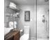 Modern bathroom featuring a marble shower, glass shelving, and contemporary design at 2604 Elm St, Denver, CO 80207