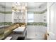 Modern bathroom with glass shower, sleek fixtures, and decorative shelving at 2604 Elm St, Denver, CO 80207