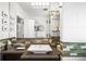 Elegant bathroom with a unique vanity, stylish mirror, and modern lighting, creating a serene and luxurious space at 2604 Elm St, Denver, CO 80207