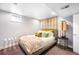 Cozy bedroom featuring a comfortable bed, stylish decor, and soft natural light from the window at 2604 Elm St, Denver, CO 80207