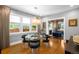 Bright dining room with hardwood floors, glass table, and adjacent sitting room at 2604 Elm St, Denver, CO 80207