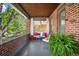 Charming front porch with brick accents, stylish seating, and inviting curb appeal at 2604 Elm St, Denver, CO 80207