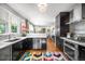 Modern kitchen with stainless steel appliances, dark cabinetry, and hardwood floors, combining style and functionality at 2604 Elm St, Denver, CO 80207