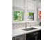 Modern kitchen sink with white countertop and bright window views at 2604 Elm St, Denver, CO 80207