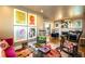 Eclectic living room featuring vibrant artwork, stylish furniture, and hardwood floors for a unique aesthetic at 2604 Elm St, Denver, CO 80207