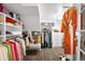 Spacious walk-in closet with custom shelving, hanging racks, and a stylish leopard print carpet at 2604 Elm St, Denver, CO 80207