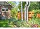 Brick home with healthy garden and birch trees in the yard at 2604 Elm St, Denver, CO 80207