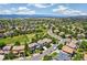 Expansive aerial view of a suburban neighborhood with lush green spaces and mountain views at 3411 Springbriar Dr, Castle Rock, CO 80109