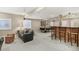 Open basement area with bar seating, air hockey, and a comfortable couch for relaxing at 3411 Springbriar Dr, Castle Rock, CO 80109