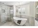Modern bathroom with a soaking tub, glass-enclosed shower, and elegant fixtures, creating a spa-like atmosphere at 3411 Springbriar Dr, Castle Rock, CO 80109