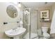 Cozy bathroom with tiled shower stall, modern vanity, and decorative mirror at 3411 Springbriar Dr, Castle Rock, CO 80109