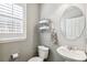 Well-lit powder room featuring a stylish sink, oval mirror, and modern towel rack at 3411 Springbriar Dr, Castle Rock, CO 80109