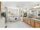 Spacious bathroom with a freestanding tub, walk-in shower, and dual vanities with granite countertops and ample storage at 3411 Springbriar Dr, Castle Rock, CO 80109
