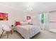 Cozy bedroom with a white iron bed frame, pink walls, and a bright window with sheer curtains at 3411 Springbriar Dr, Castle Rock, CO 80109