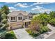 Two-story home features a well manicured front yard with mature trees and a neutral color scheme at 3411 Springbriar Dr, Castle Rock, CO 80109