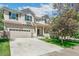Two-story home with neutral siding, a well manicured lawn, and a two car garage with mature trees at 3411 Springbriar Dr, Castle Rock, CO 80109