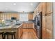 Modern kitchen with wood cabinets, stainless appliances, granite counters, and stylish backsplash at 3411 Springbriar Dr, Castle Rock, CO 80109