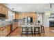 Spacious kitchen with wood cabinets, granite counters, stainless appliances, and a large center island at 3411 Springbriar Dr, Castle Rock, CO 80109