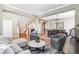 Open-concept living room with hardwood floors, neutral paint, dining area, and a staircase to the second floor at 3411 Springbriar Dr, Castle Rock, CO 80109