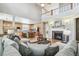 Open concept living room with light hardwood flooring, fireplace, and eat-in kitchen with stainless appliances at 3411 Springbriar Dr, Castle Rock, CO 80109