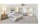 Serene main bedroom with tray ceilings, a sitting area, and an ensuite bathroom featuring a soaking tub at 3411 Springbriar Dr, Castle Rock, CO 80109