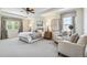 Bright main bedroom featuring neutral colors, soft carpet, a sitting area, and large windows offering ample natural light at 3411 Springbriar Dr, Castle Rock, CO 80109