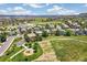 Aerial view showcasing a community with green spaces and pathways winding through residential areas at 3411 Springbriar Dr, Castle Rock, CO 80109