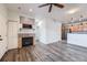 Living room with fireplace, wood-look floors, and kitchen views at 16312 E Fremont Ave # 2, Aurora, CO 80016