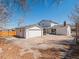 Aerial view of the backyard featuring a garage, patio, and the home's exterior at 10415 Owens Cir, Broomfield, CO 80021
