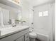 Bright bathroom featuring a shower-tub, sink, white tile, and modern fixtures at 10415 Owens Cir, Broomfield, CO 80021