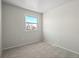 Bright bedroom with neutral walls and carpet, featuring a window with a view at 10415 Owens Cir, Broomfield, CO 80021