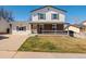 Charming two-story home featuring a welcoming front porch and well-maintained lawn at 10415 Owens Cir, Broomfield, CO 80021