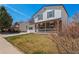 Inviting two-story house featuring a bright, well-maintained lawn and covered front porch at 10415 Owens Cir, Broomfield, CO 80021